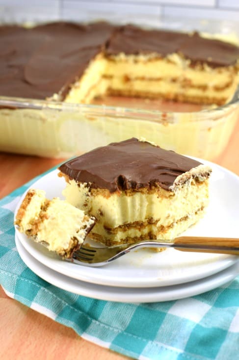 Slice of chocolate eclair cake with a bite taken out.