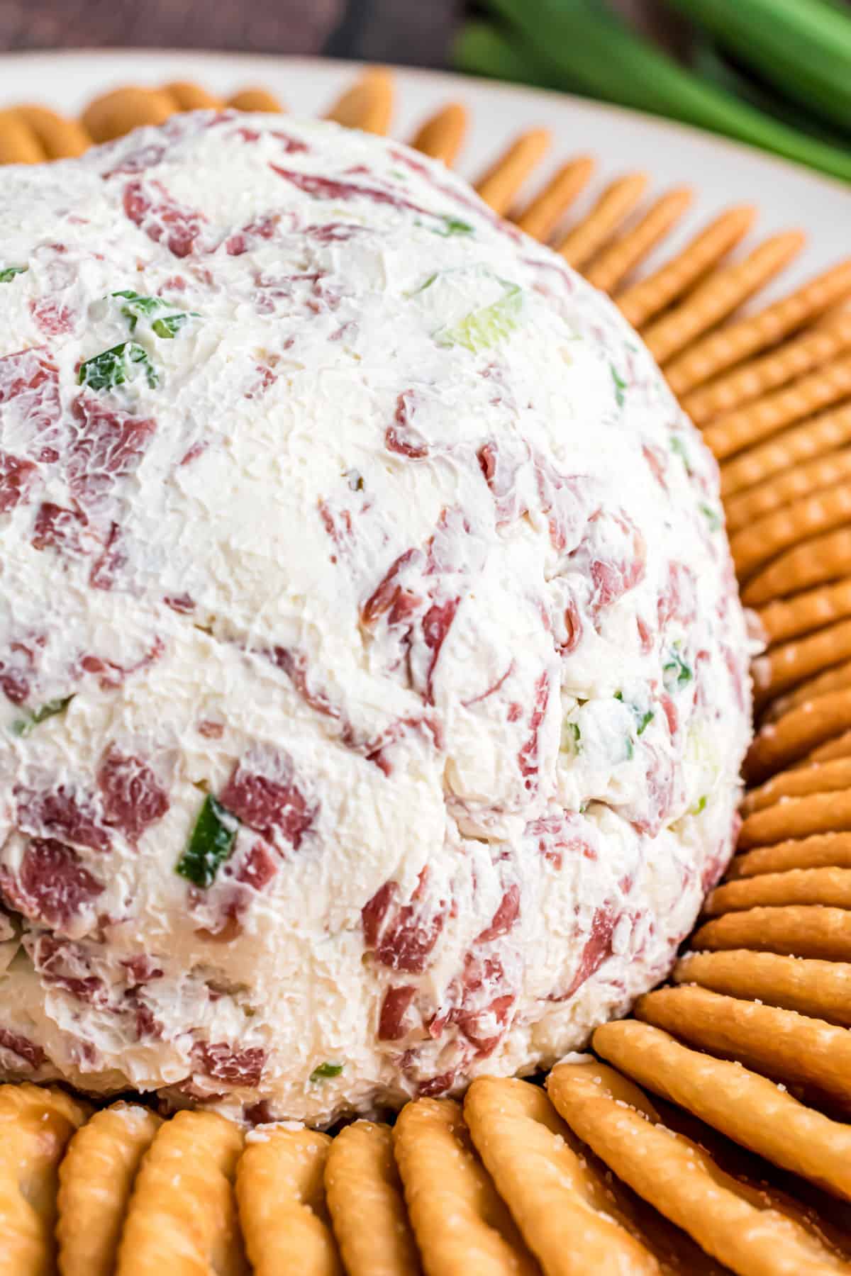 Chipped beef cheese ball served on a platter with buttery townhouse crackers.