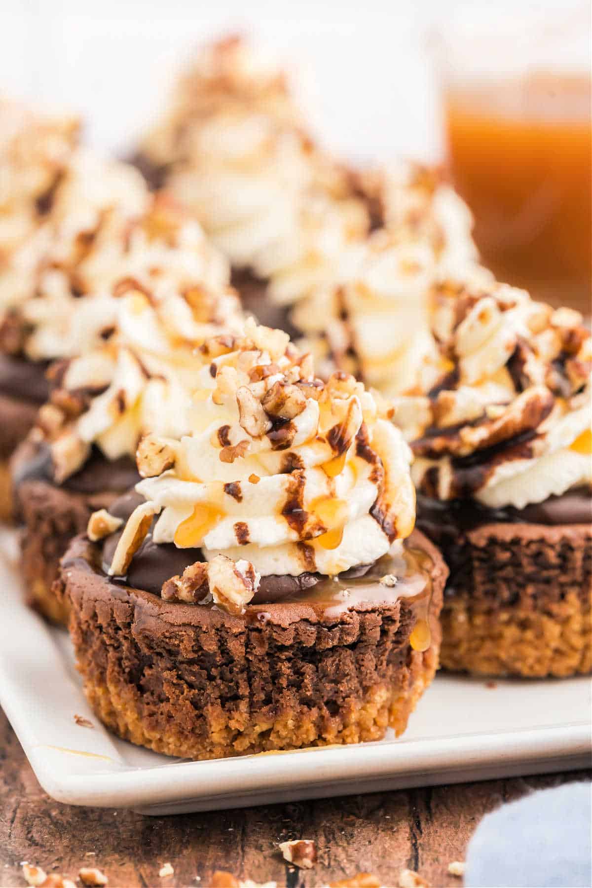 Chocolate caramel cheesecakes served on a white plate.