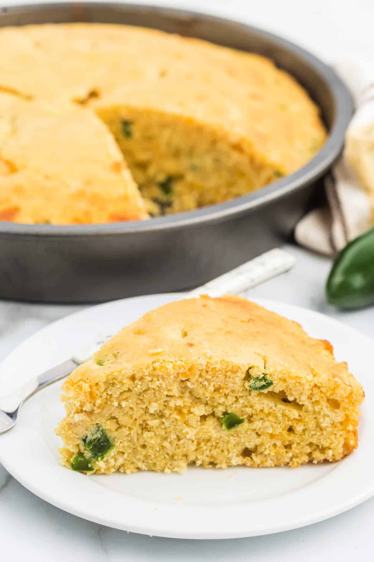 Slice of jalapeno cheddar cornbread on a plate.