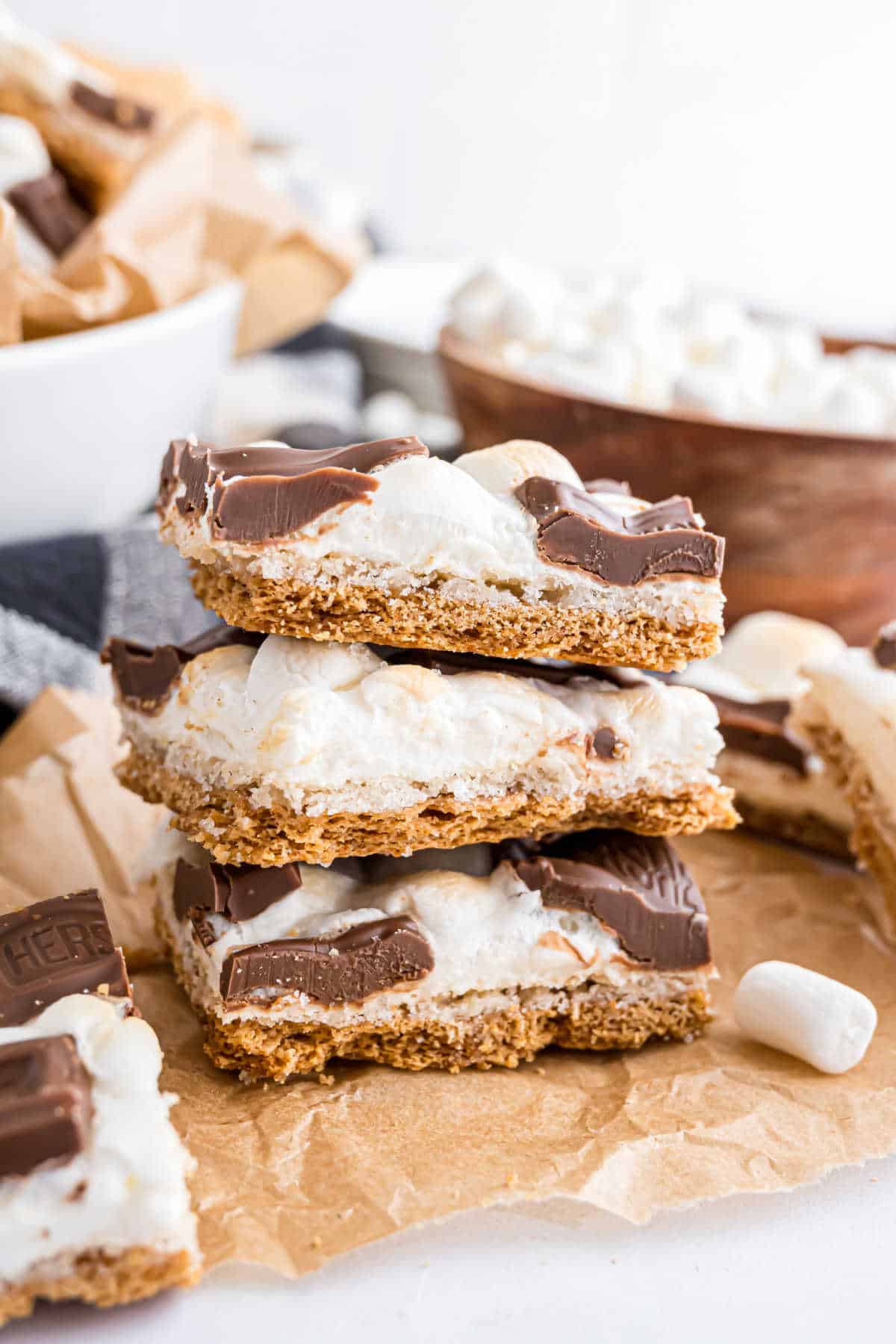 Stack of three pieces of s'mores toffee on a piece of parchment paper.