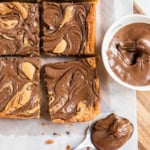 Nutella Swirled Blondies are decadence at its finest. Topped with vanilla ice cream and drizzled with melted Nutella, these blondies are fudgy, sweet and easy to make!