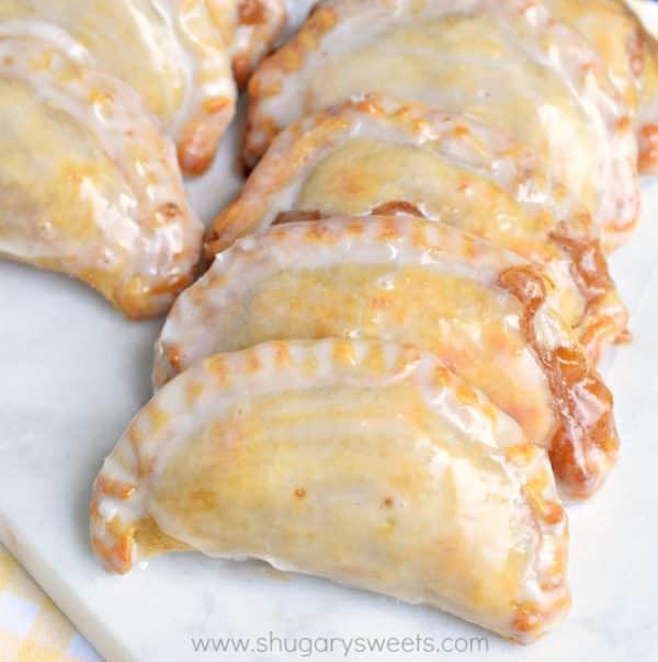 Dessert is ready in 30 minutes with these Glazed Peach Hand Pies! The flaky crust and spicy cinnamon filling are the perfect combo in a hand pie, plus they're baked not fried!