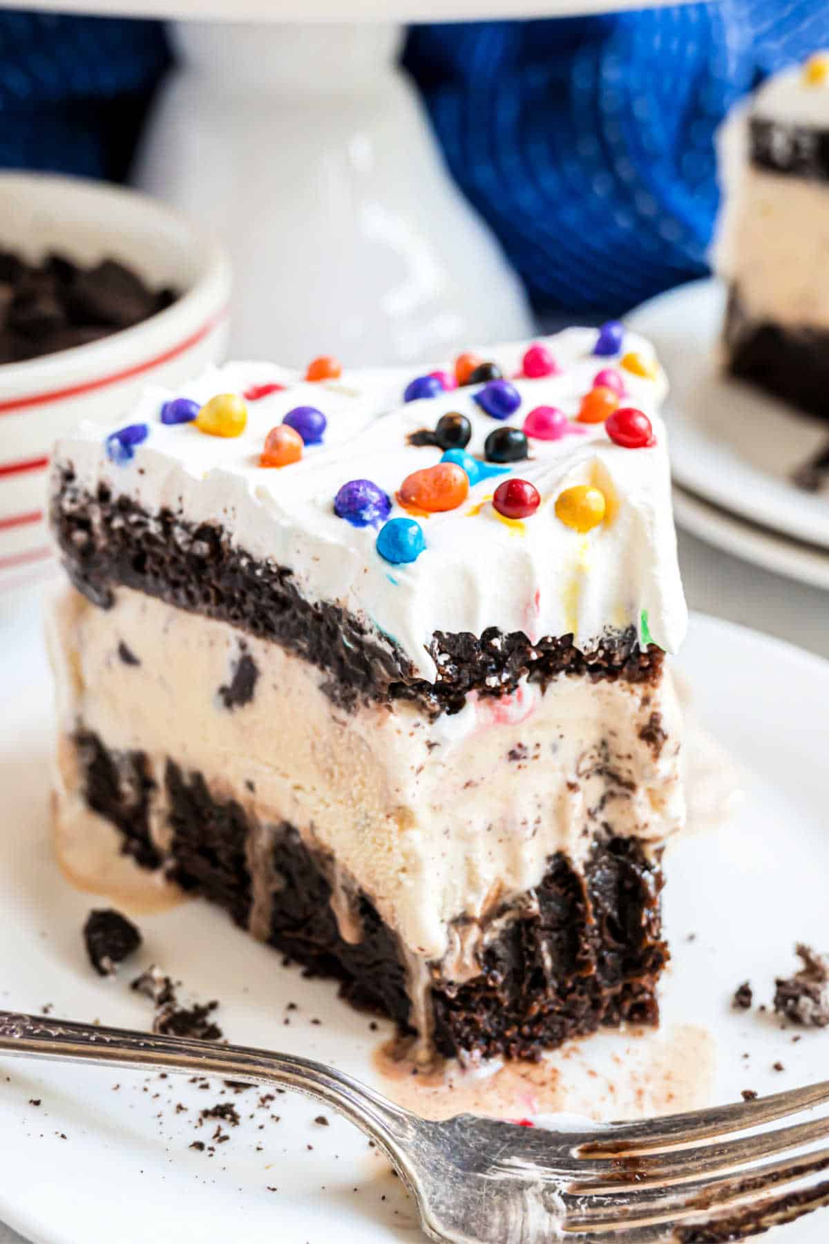 Slice of brownie ice cream cake with a bite taken out.