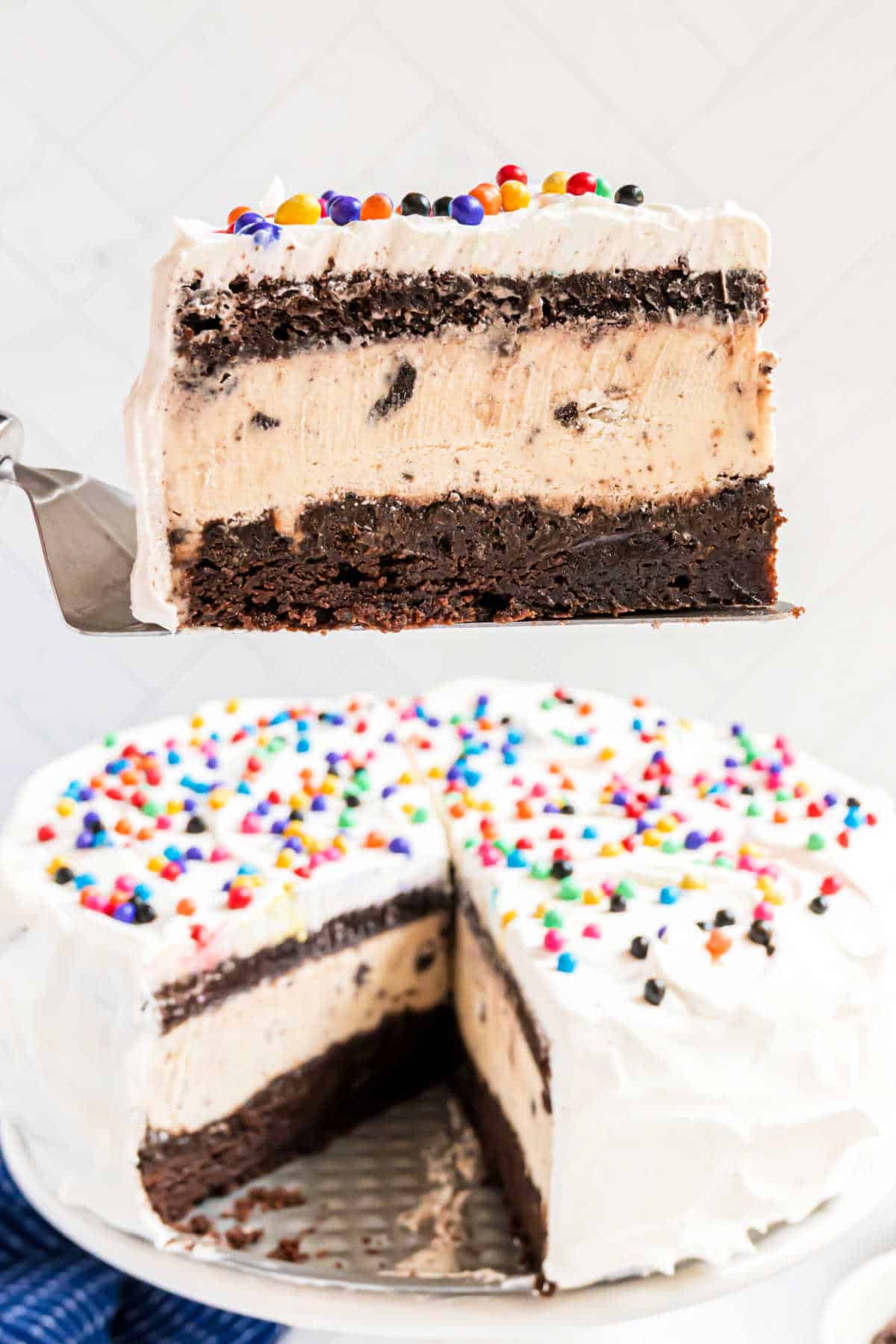Slice of brownie ice cream cake being lifted out of pan.