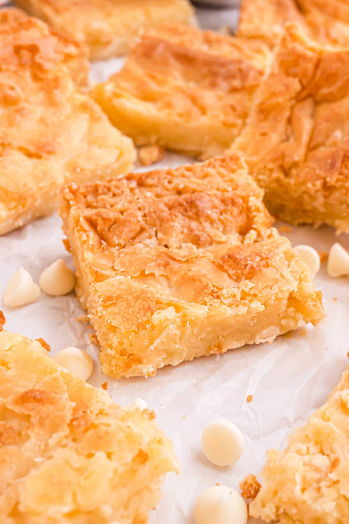 White chocolate brownies cut into squares on parchment paper.