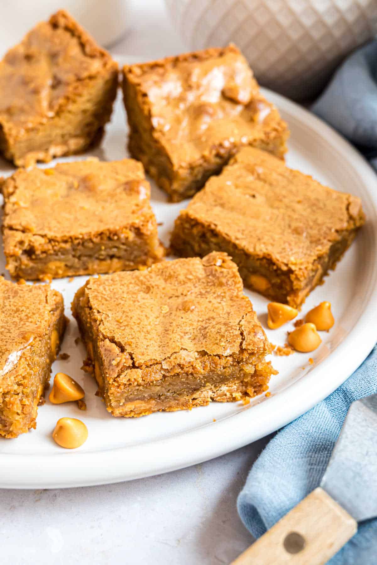 Blondie squares on a white serving plate.