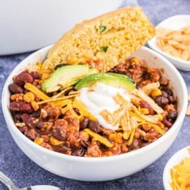 Slow Cooker meals are not only perfect for busy weeknight dinners, but also great for weekend entertaining too! Serve this easy Taco Chili recipe with a side of cornbread and all the fixings for a flavorful dinner.