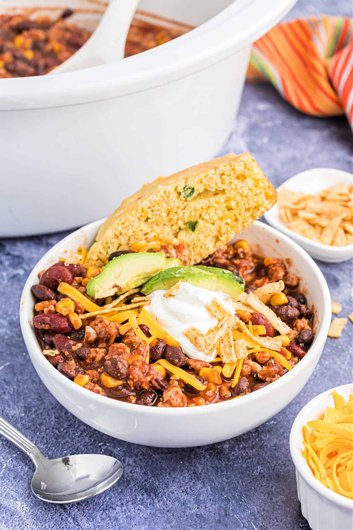 Bowl of taco chili with a side or cornbread.