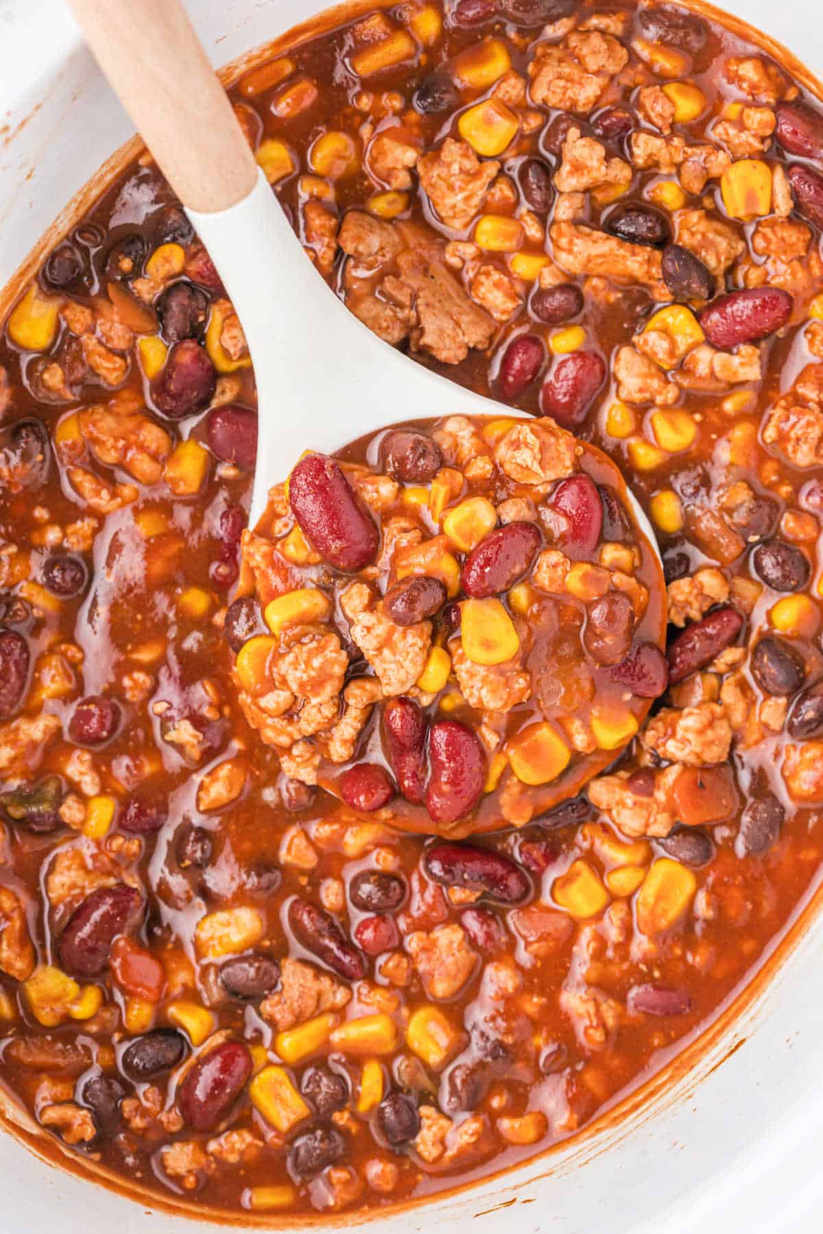 Taco chili cooked in a white crockpot.