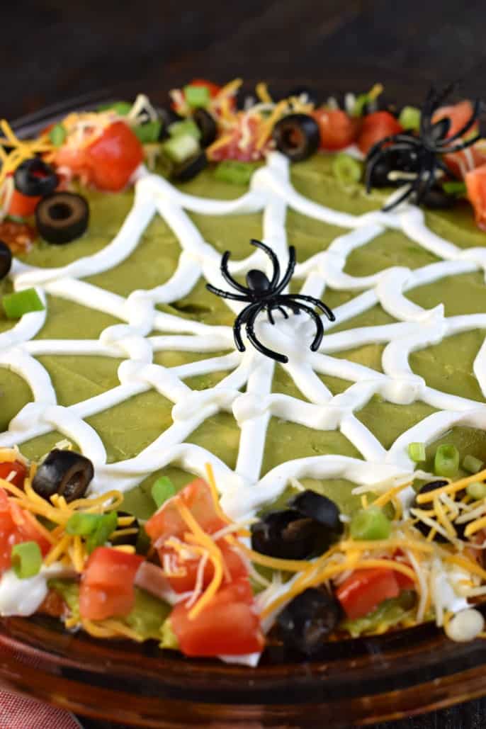 Taco Dip decorated to look like a spider web for Halloween.