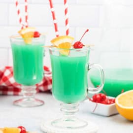 This fun and fruity alcoholic Grinch Drink is the perfect cocktail recipe for your upcoming Christmas holiday party! Made with rum, schnapps, OJ and blue curacao.