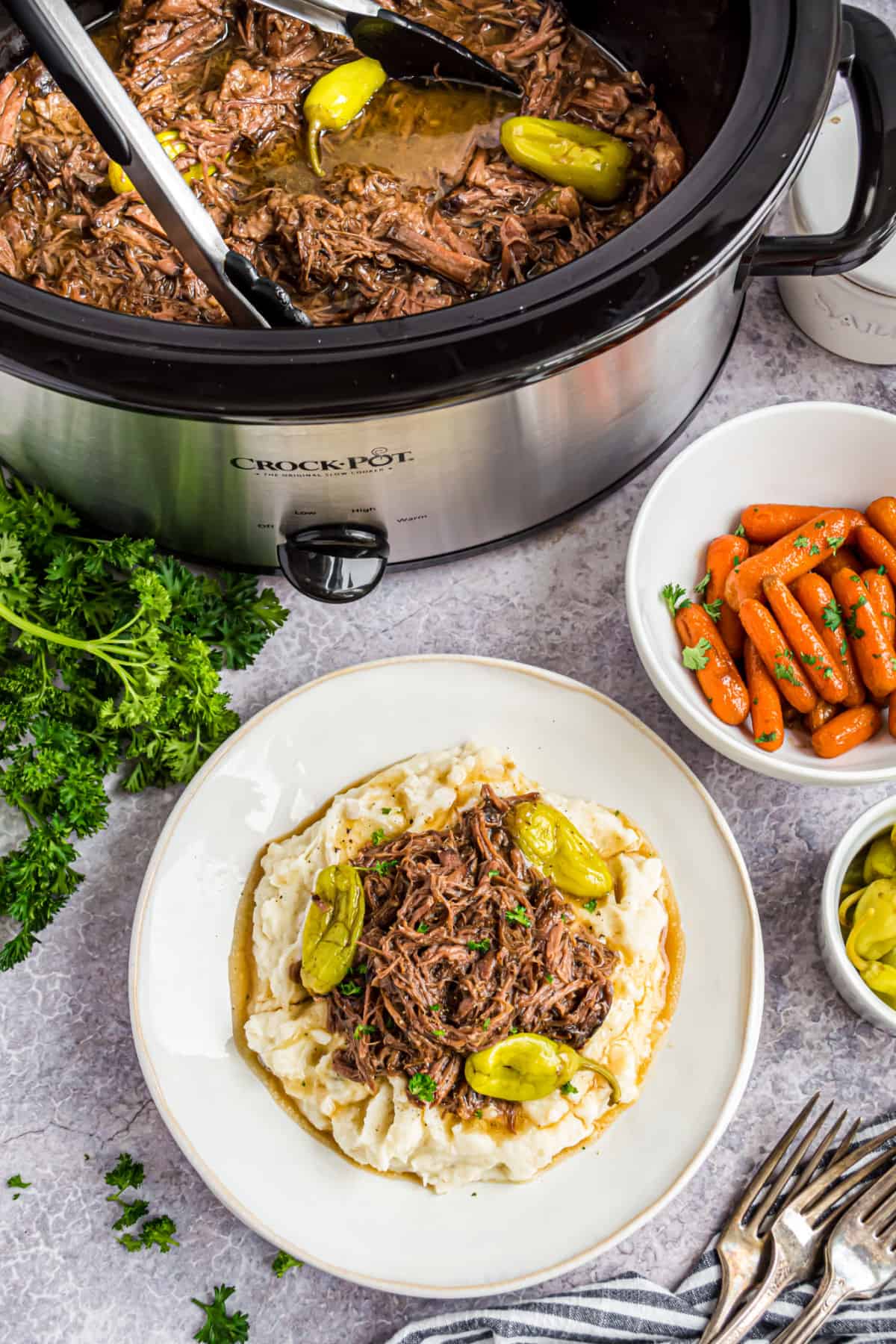 Mississippi pot roast served with mashed potatoes and carrots.