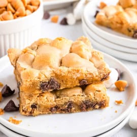 Stack of two butterscotch marshmallow bars on a white dessert plate.