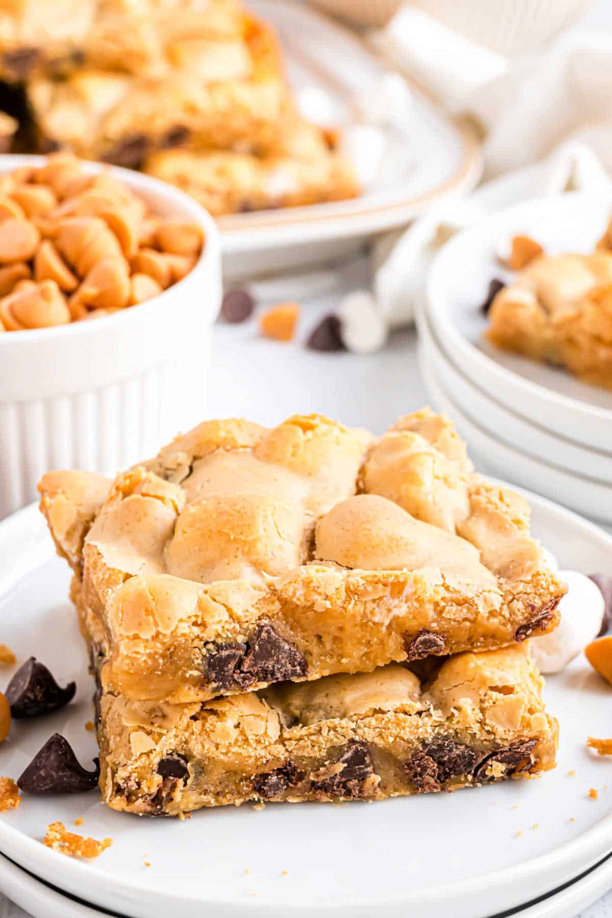 Two butterscotch marshmallow bars stacked on a white plate.