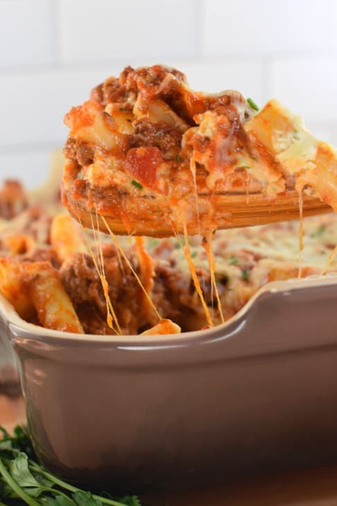 Spoonful of baked ziti with cheese pull