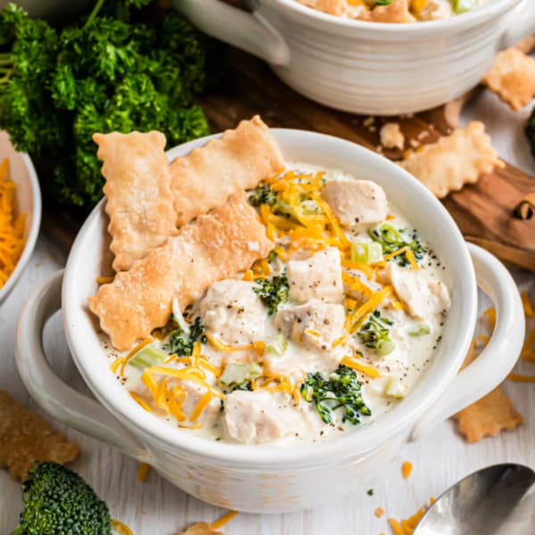 Chicken Pot Pie Soup is the ultimate comfort food dinner in an easy to serve bowl. You'll love this cozy soup recipe with buttery pie crust dippers! Ready in under 30 minutes!