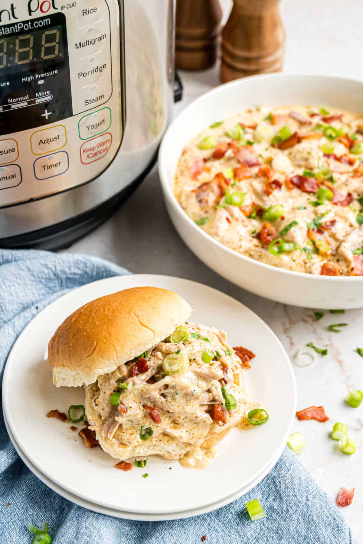 Crack chicken in a bowl served on a bun.