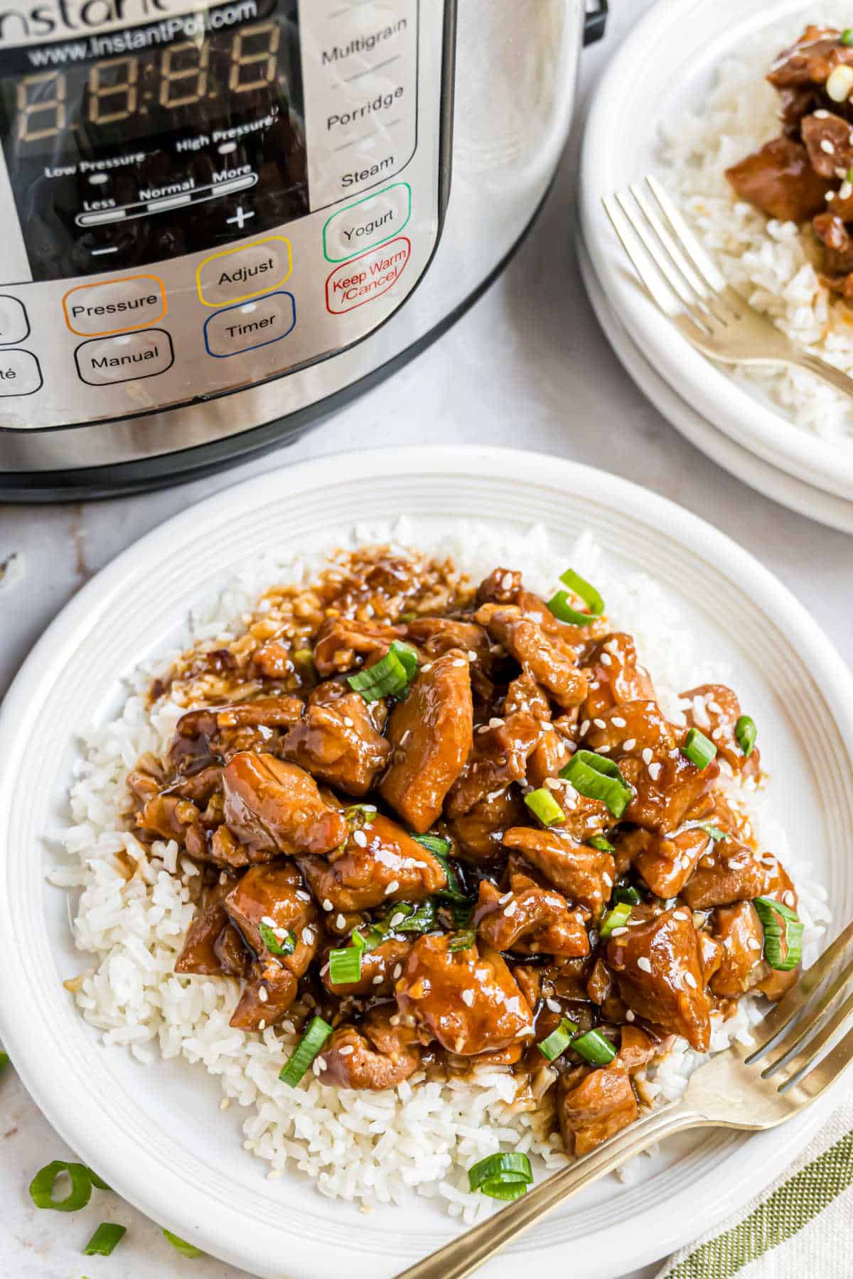 Chicken served over a bed of rice.