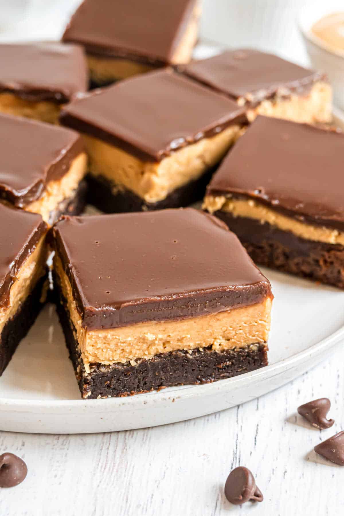 Chocolate and peanut butter layered brownies on a white plate.