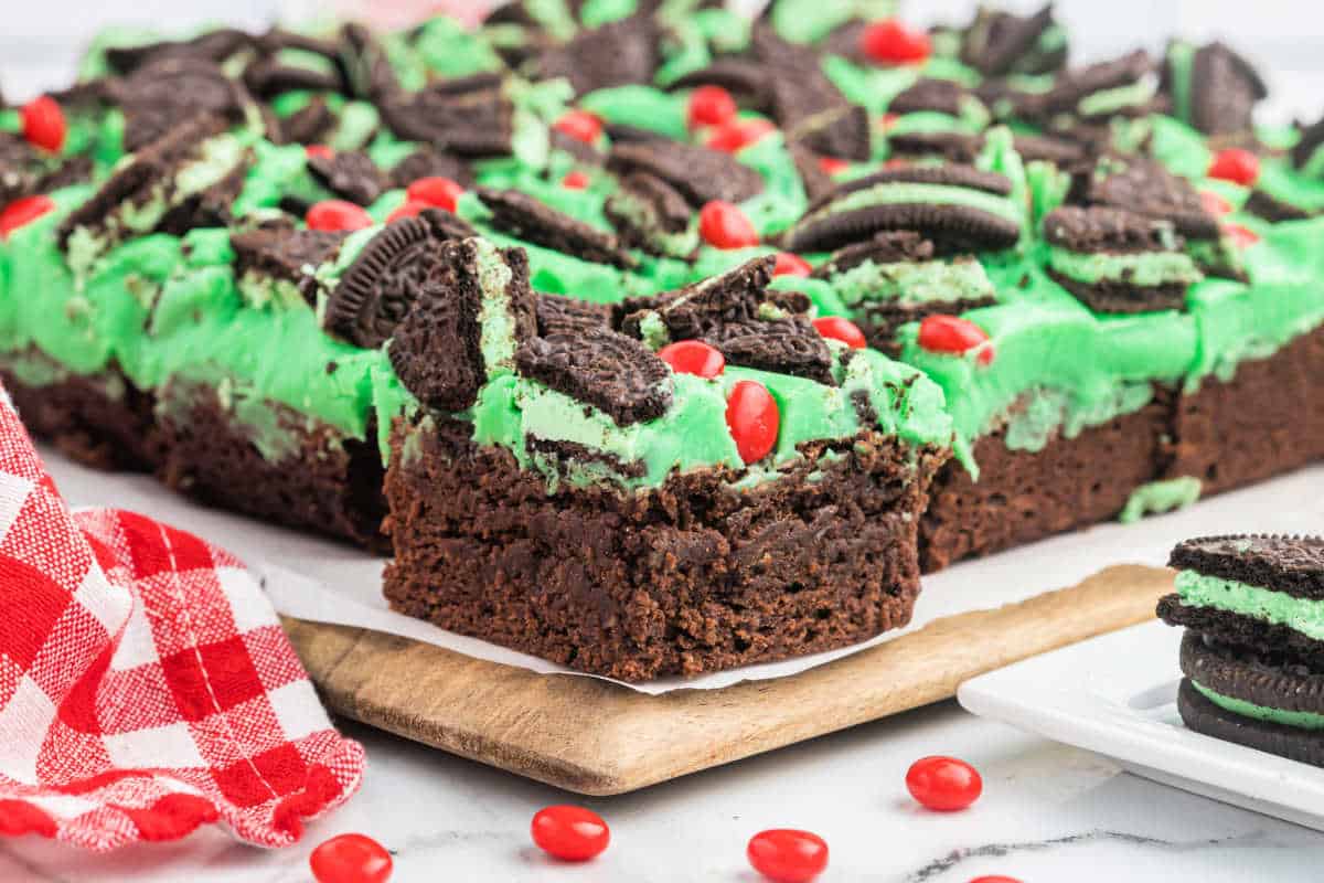 Grinch brownies on a wooden cutting board.