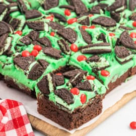 These festive Grinch Brownies are thick and fudgy, with a green mint ganache, mint Oreos, and red hot candies. Perfect for Christmas!