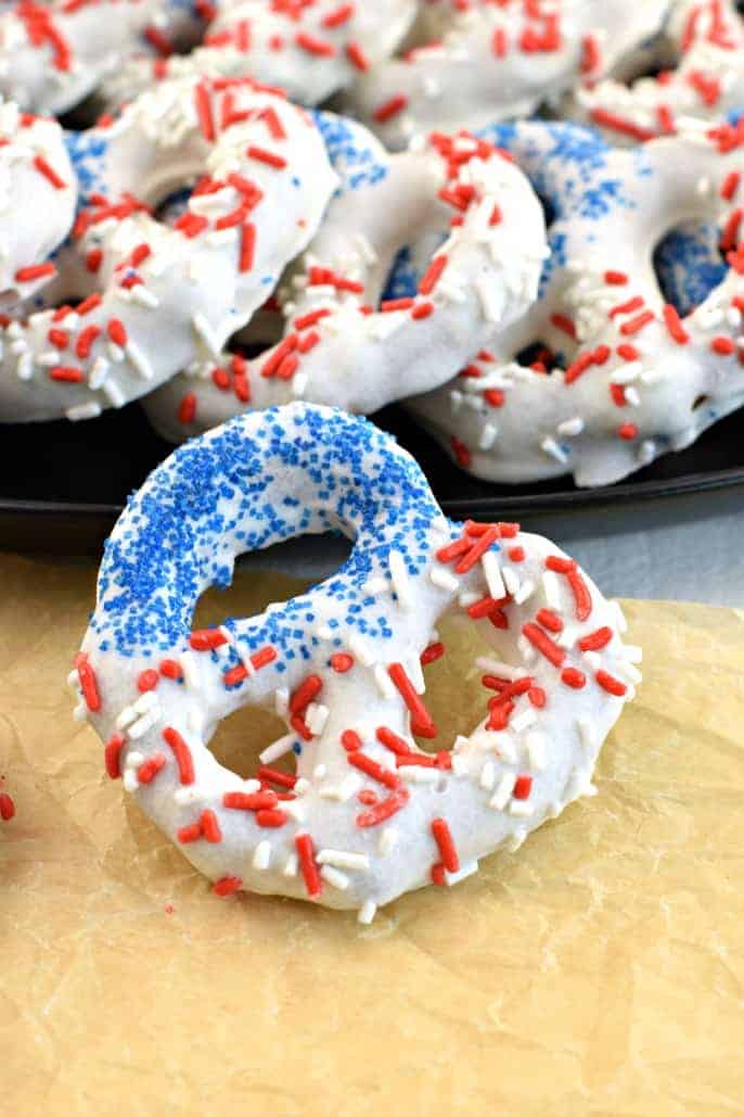 Pretzel twists covered in white chocolate and red/blue sprinkles to resemble an American flag.