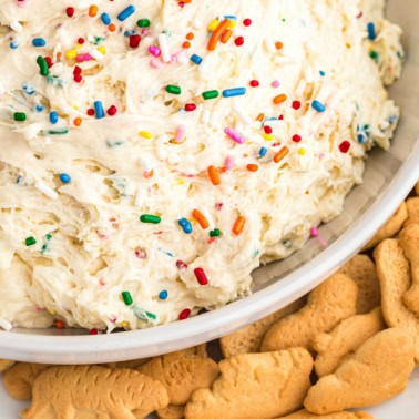 Bowl of funfetti dip with sprinkles and animal crackers.