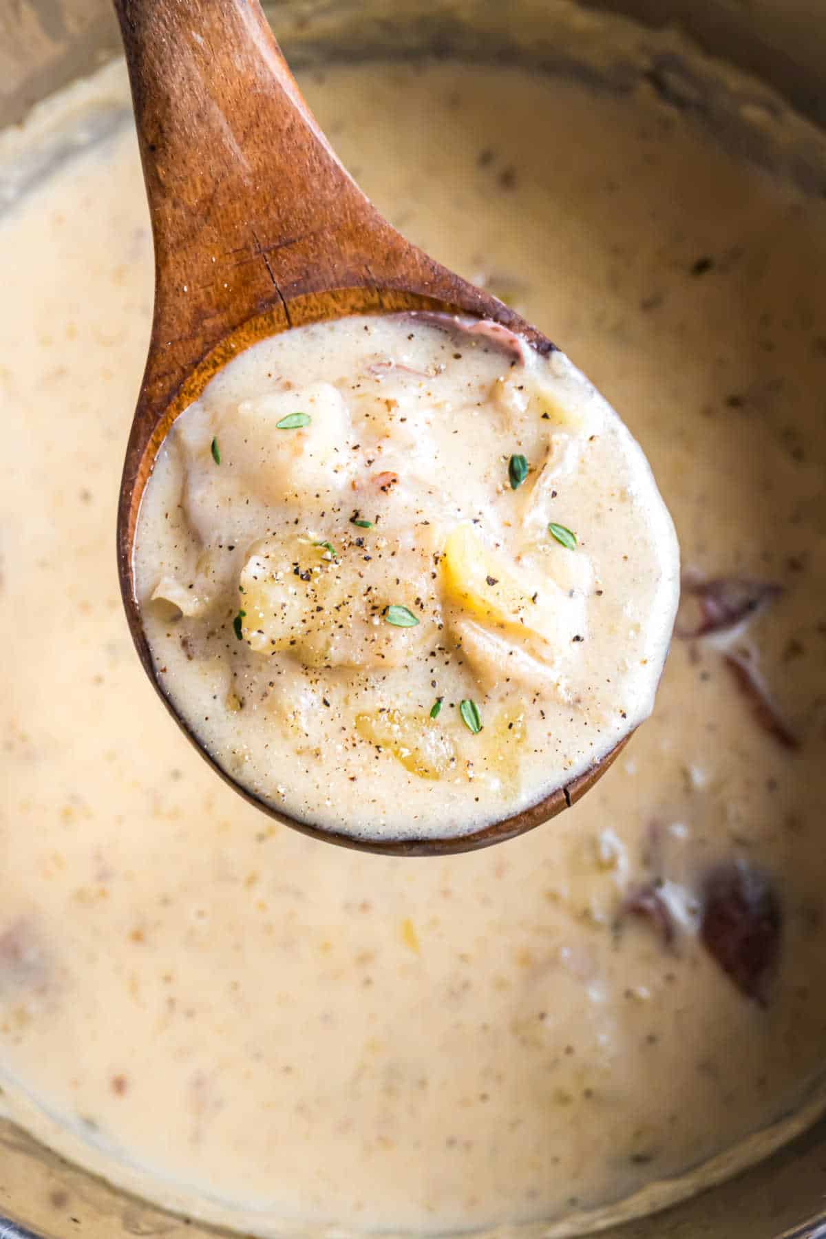 Ladle of potato soup being lifted out of instant pot.