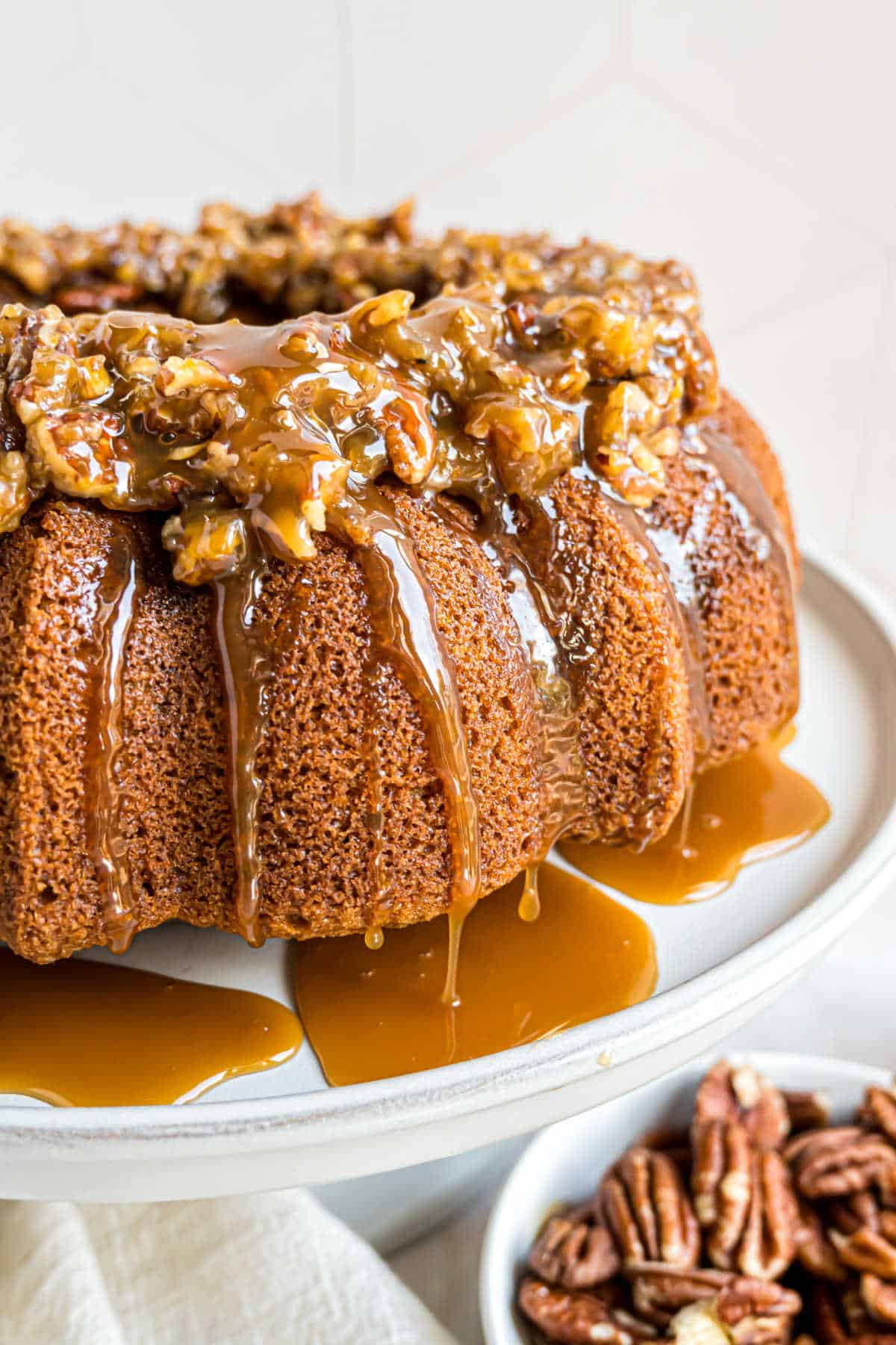 Pecan pie topped bundt cake drizzled with caramel sauce.