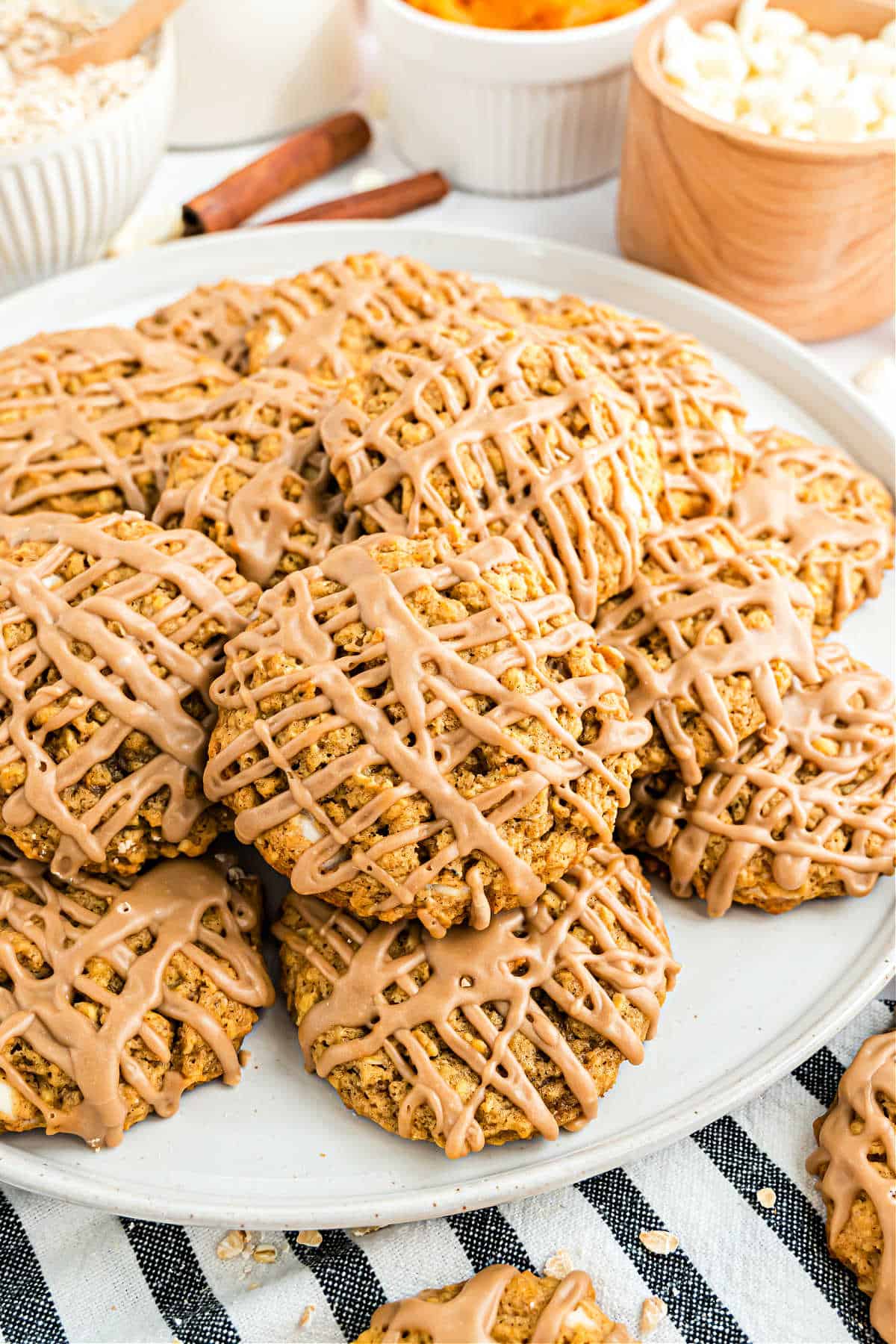 Pumpkin iced oatmeal cookies on a serving plate.