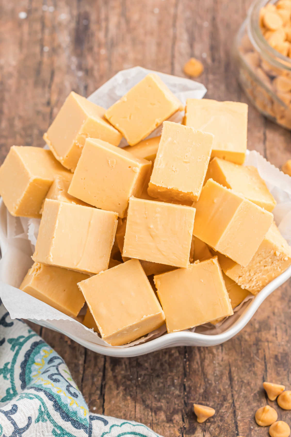 White scalloped bowl with pieces of butterscotch fudge.