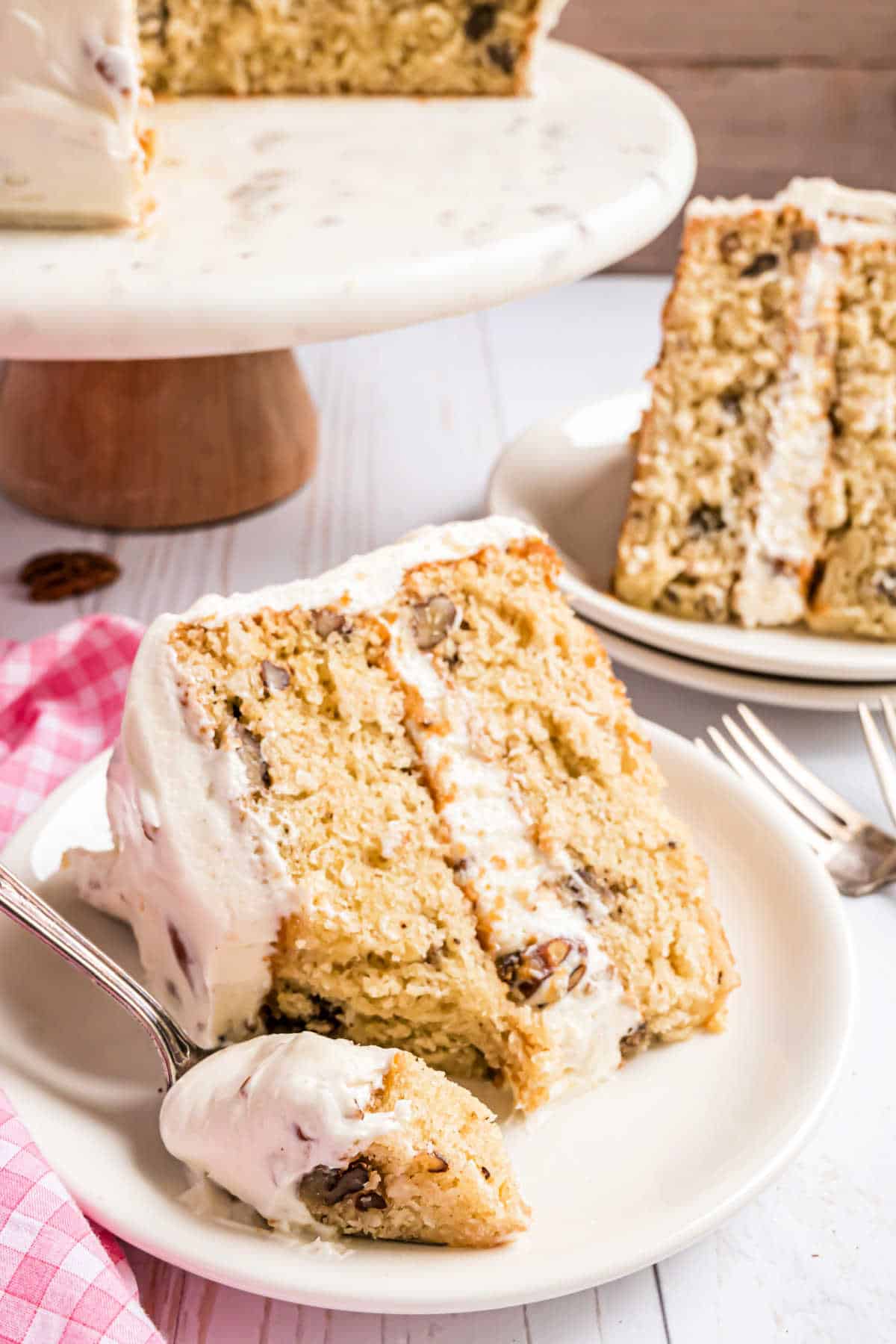 Slice of Italian cream cake with a bite taken out.