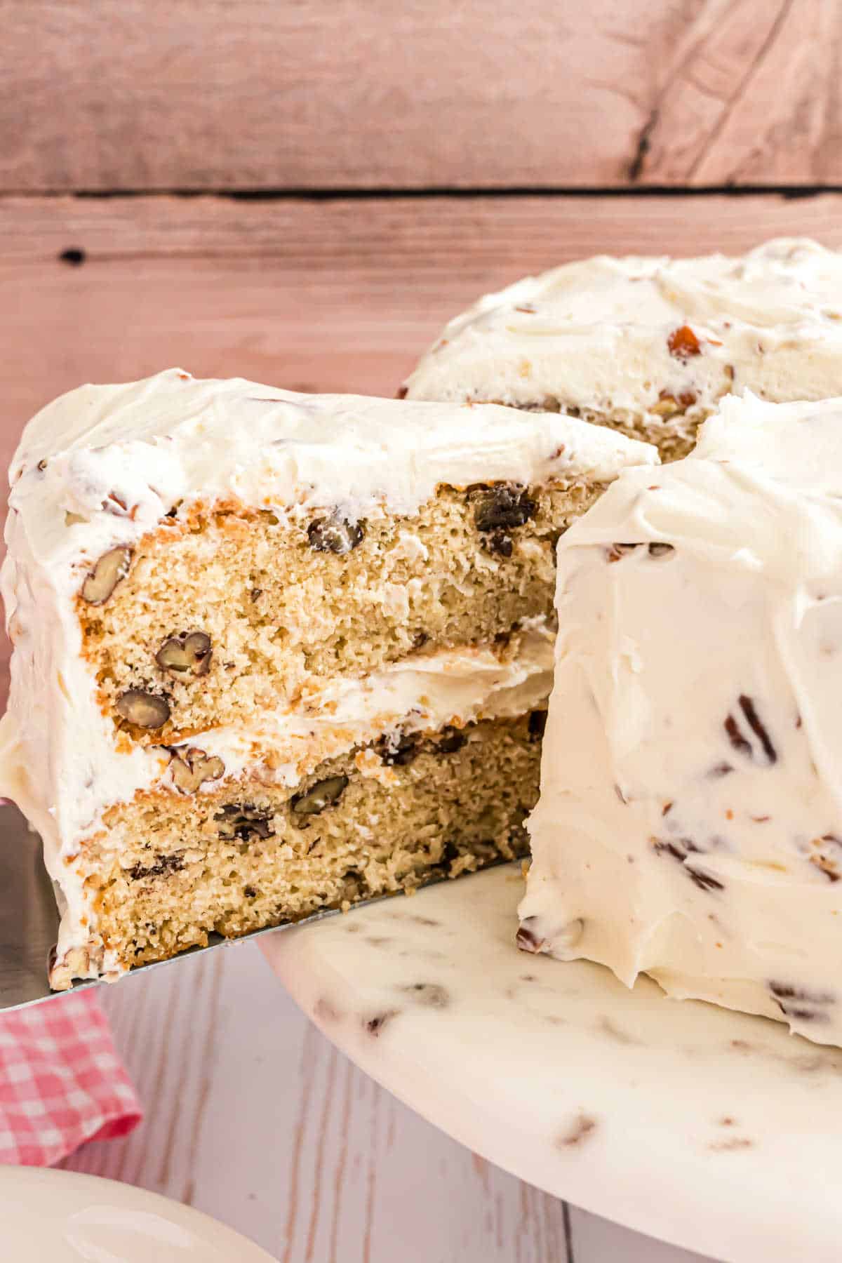 Slice of cake being removed from cake platter.