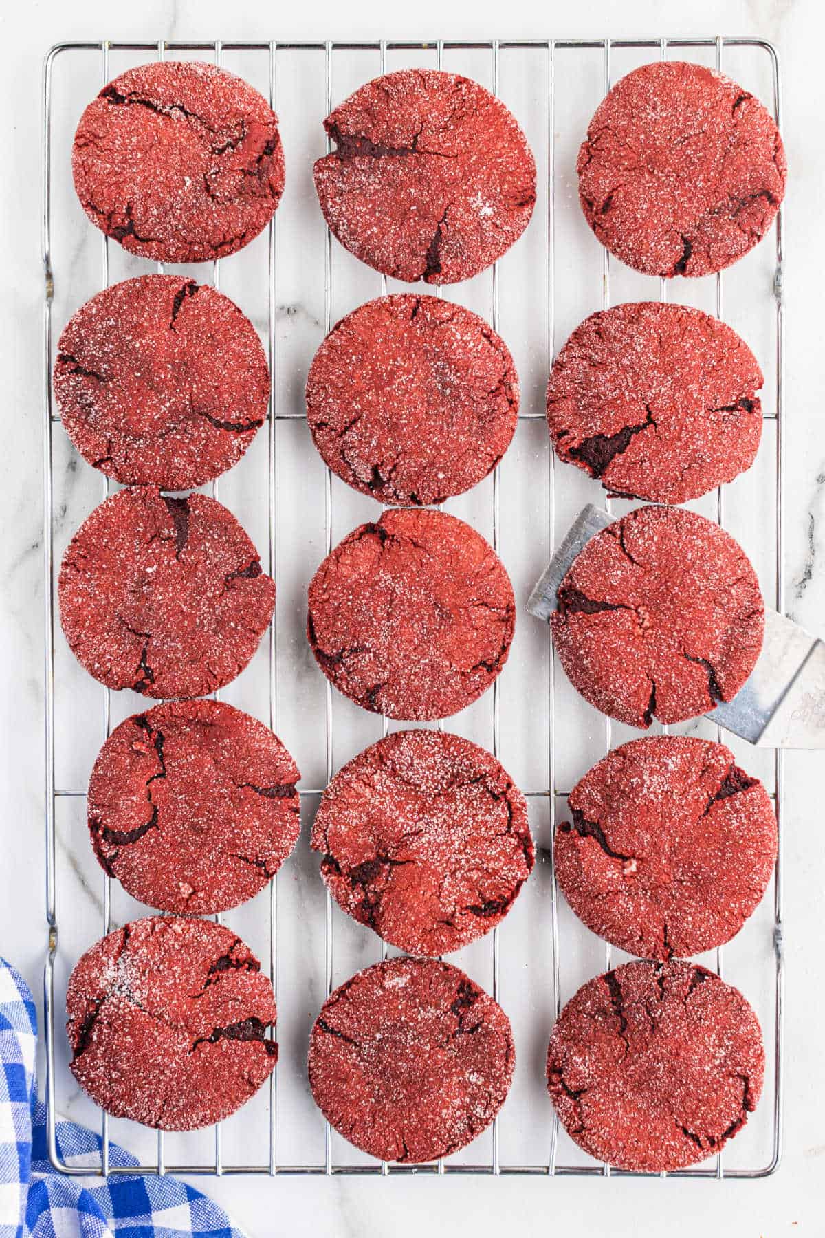 Red velvet cookies on a wire cooling rack.