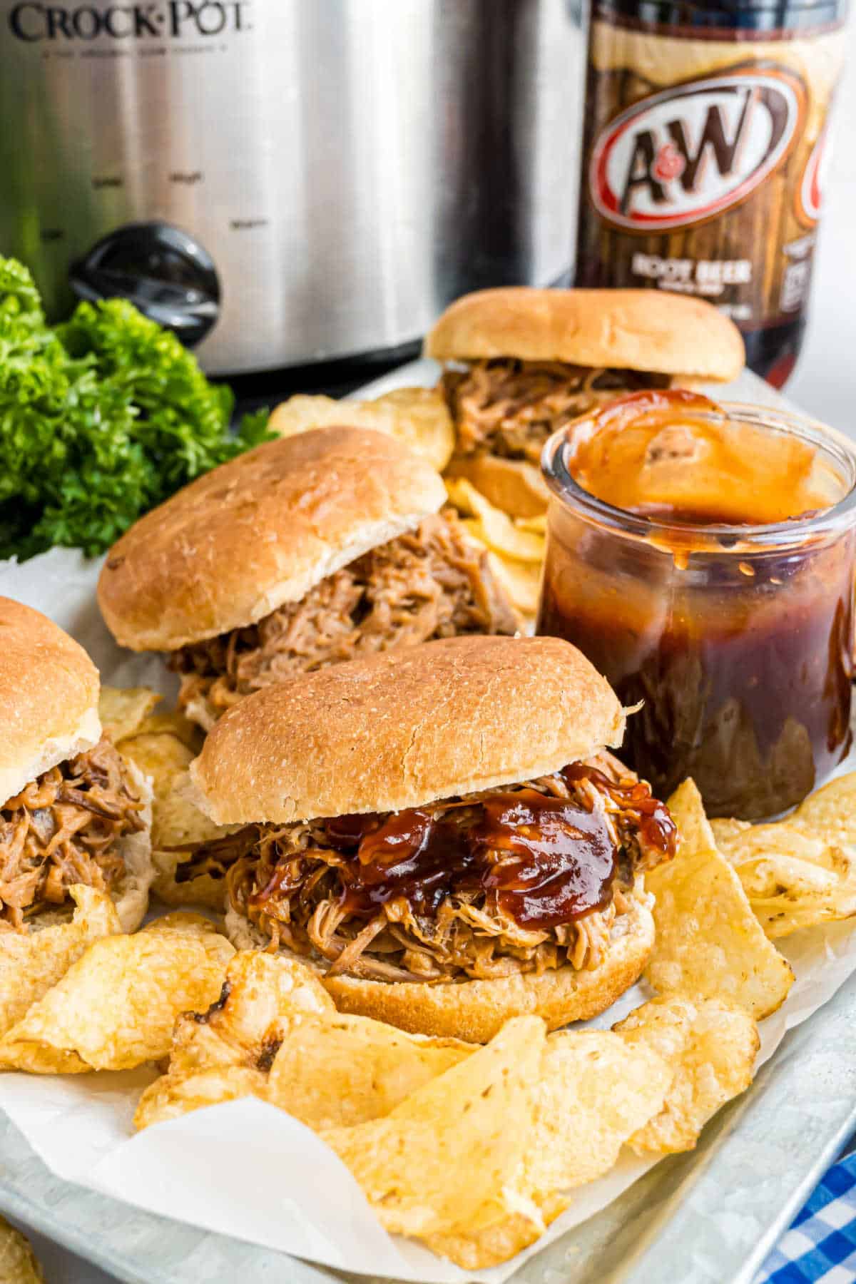 Plate of pulled pork sandwiches with root beer.