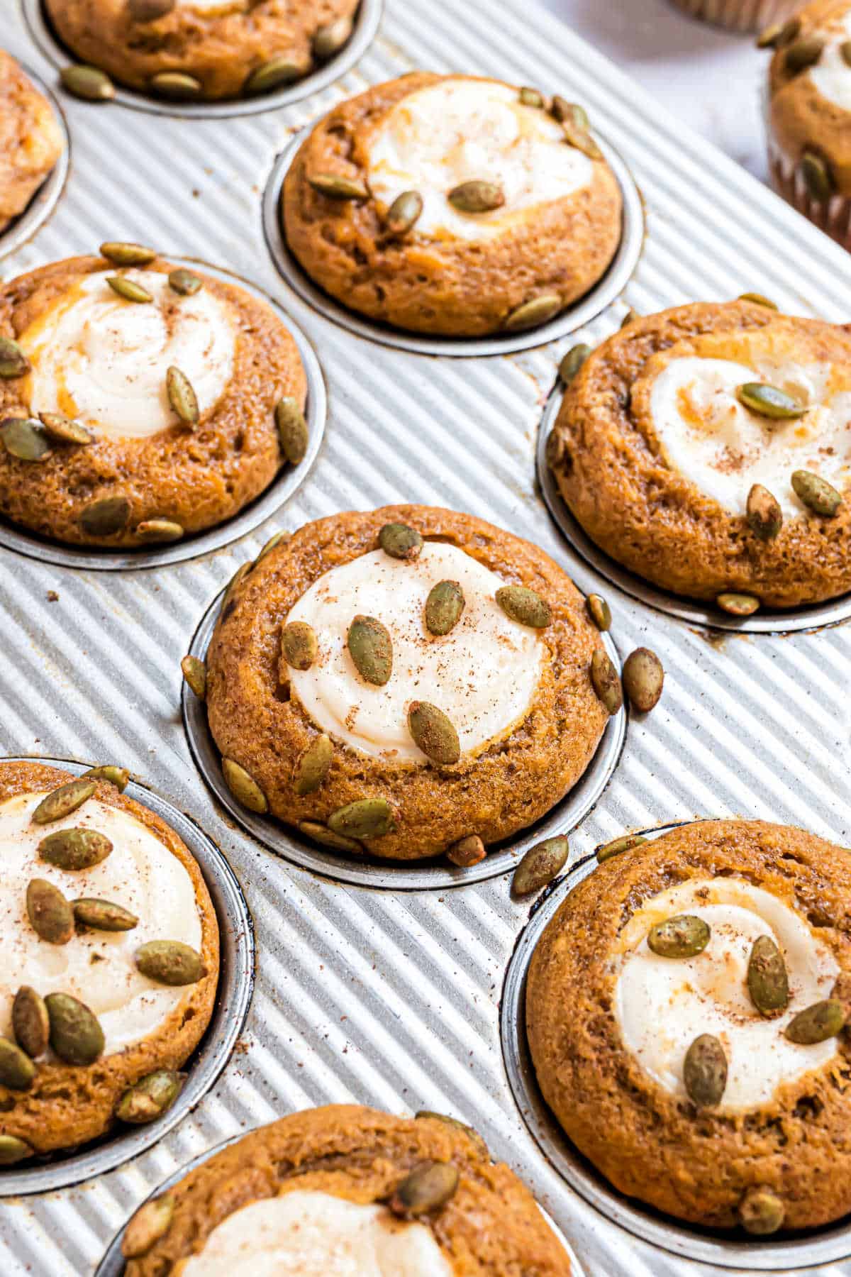 Pumpkin cream cheese muffins baked in a cupcake tin.