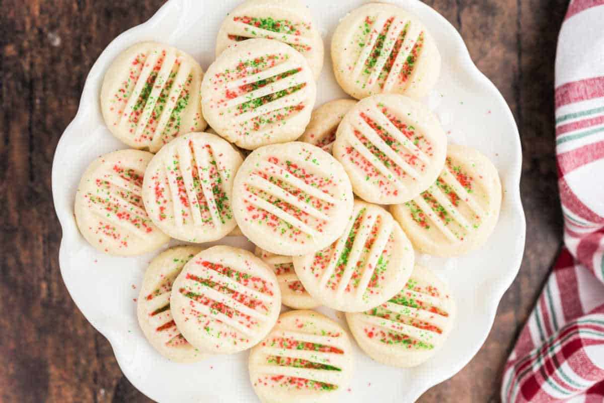 White plate stacked with shortbread cookie bites.