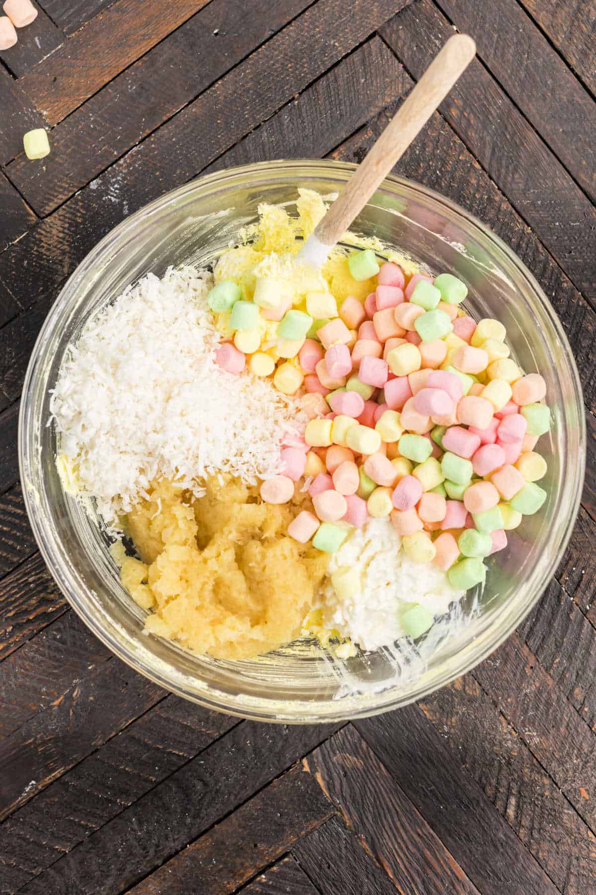 Clear mixing bowl with jello salad ingredients.