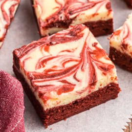 Red Velvet Cheesecake Swirl Brownies take the decadent fudgy brownie we love and elevates it to new heights. A layer of soft and creamy cheesecake swirled with ultra chocolatey red velvet brownie batter.