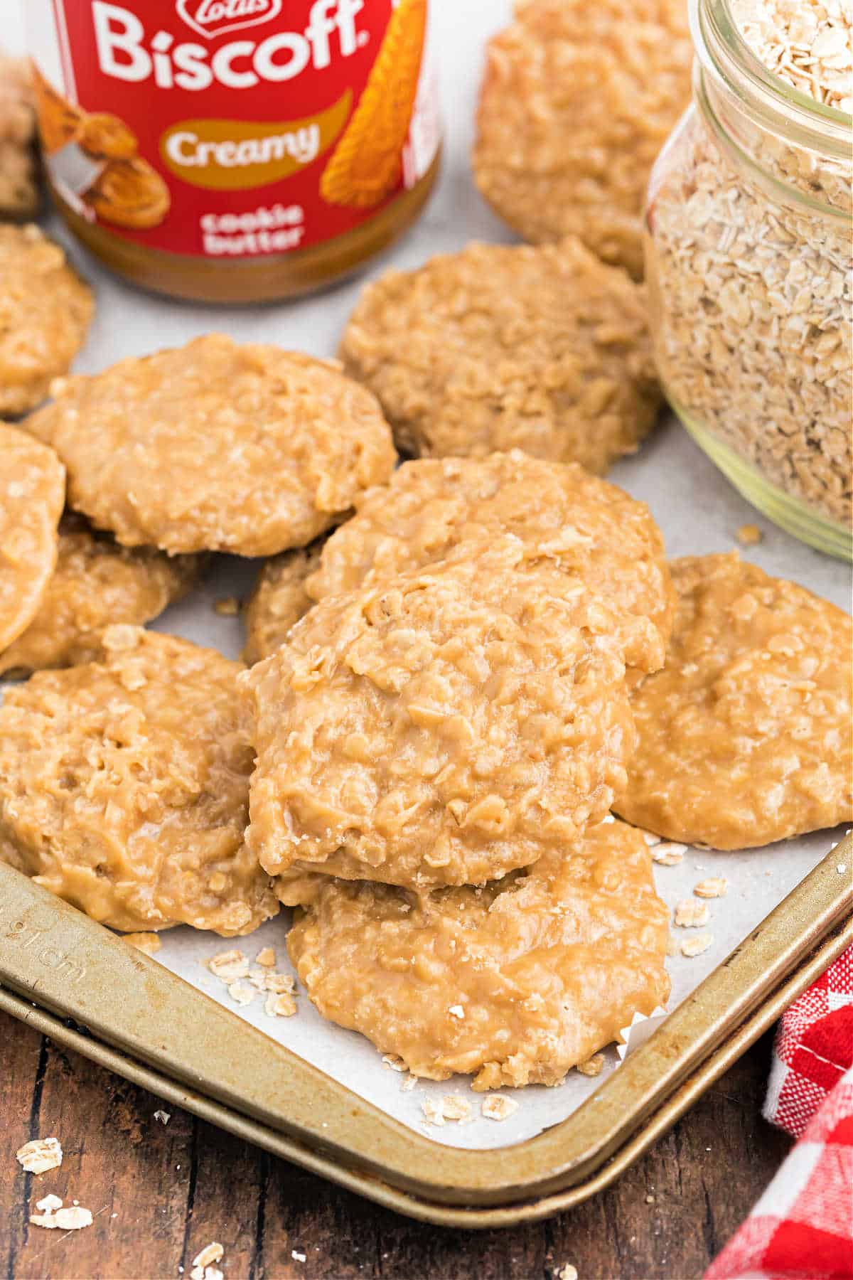 Stack of Biscoff oatmeal cookies on a parchment paper lined cookie sheet.