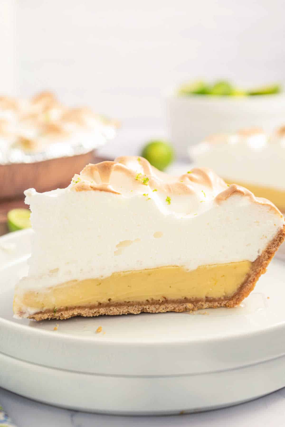 Slice of key lime pie with meringue on top.