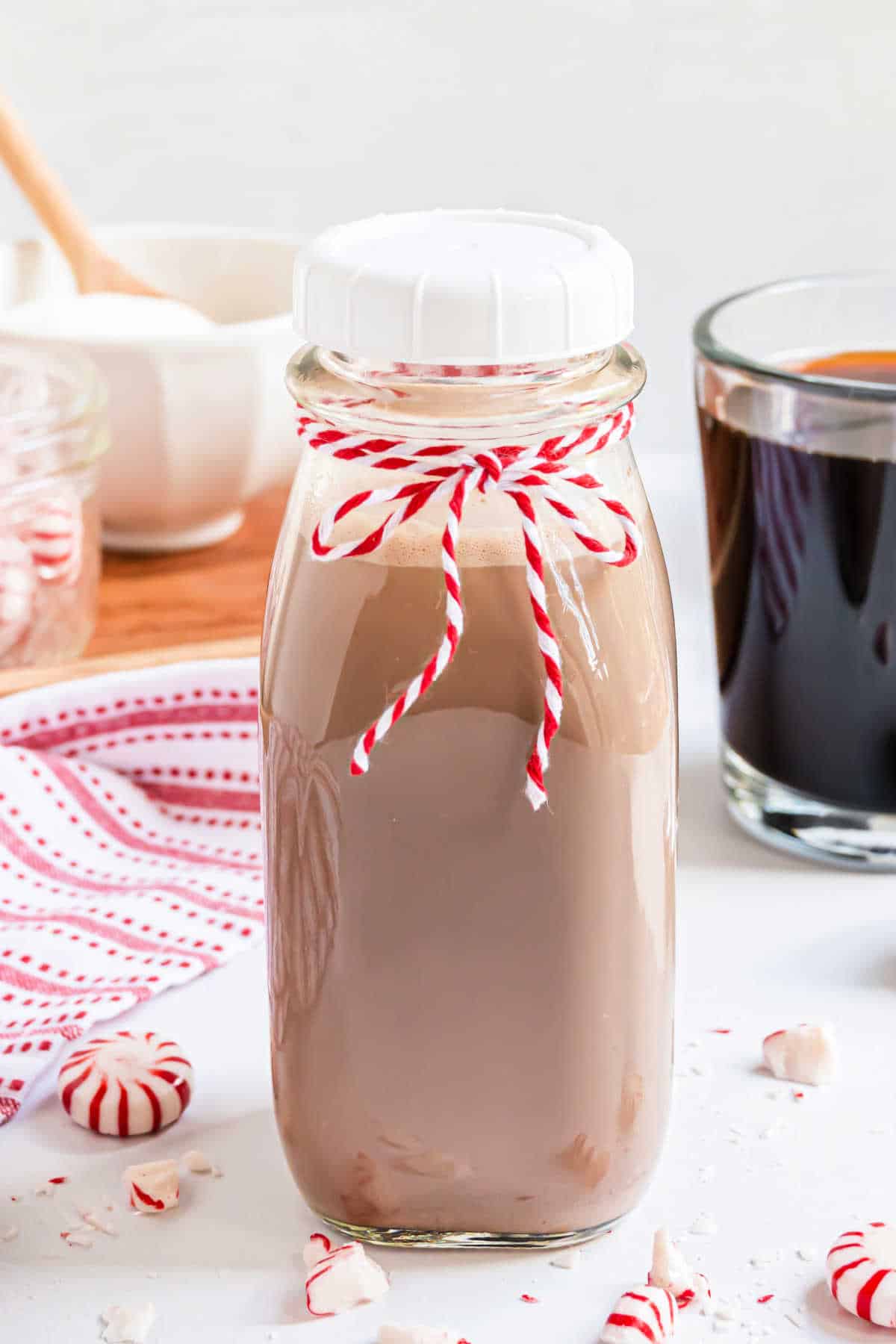 Homemade coffee creamer in a jar with ribbon.