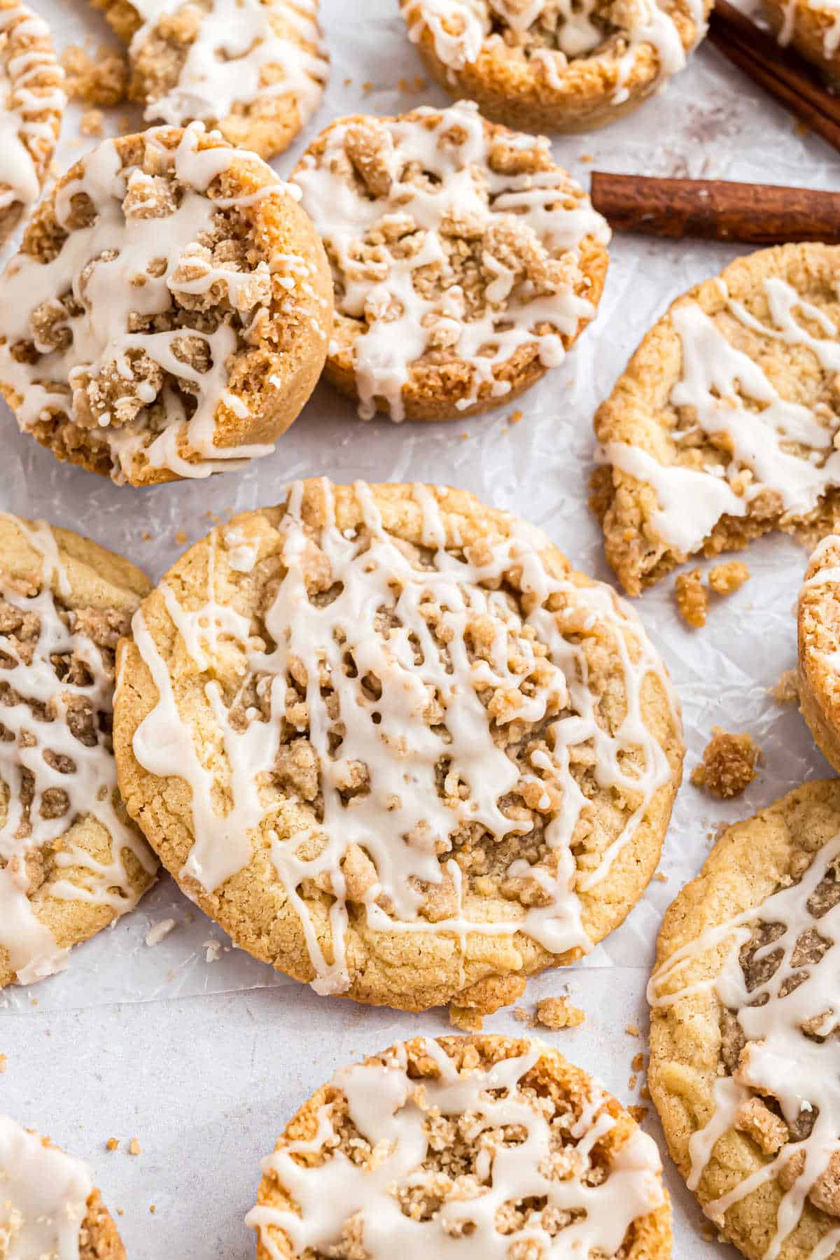 Coffee cake cookies with icing on parchment paper.