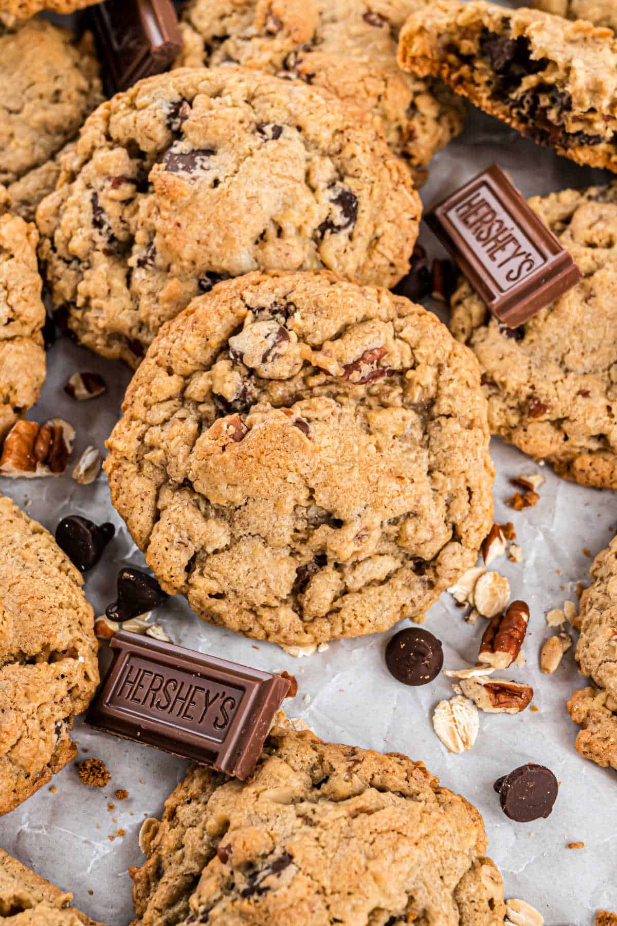 Stacks of oatmeal chocolate chip cookies on parchment paper.