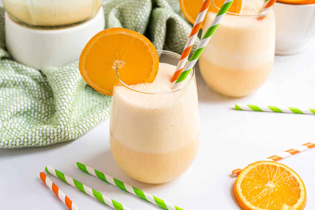 Orange julius with a slice of orange on the glass.