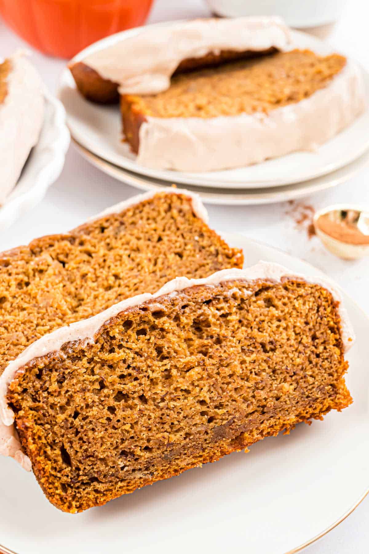 Two slices of pumpkin banana bread on a plate.