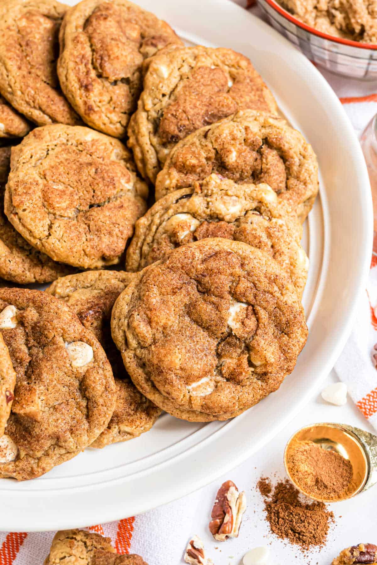 Pumpkin cookies on a white serving plate.