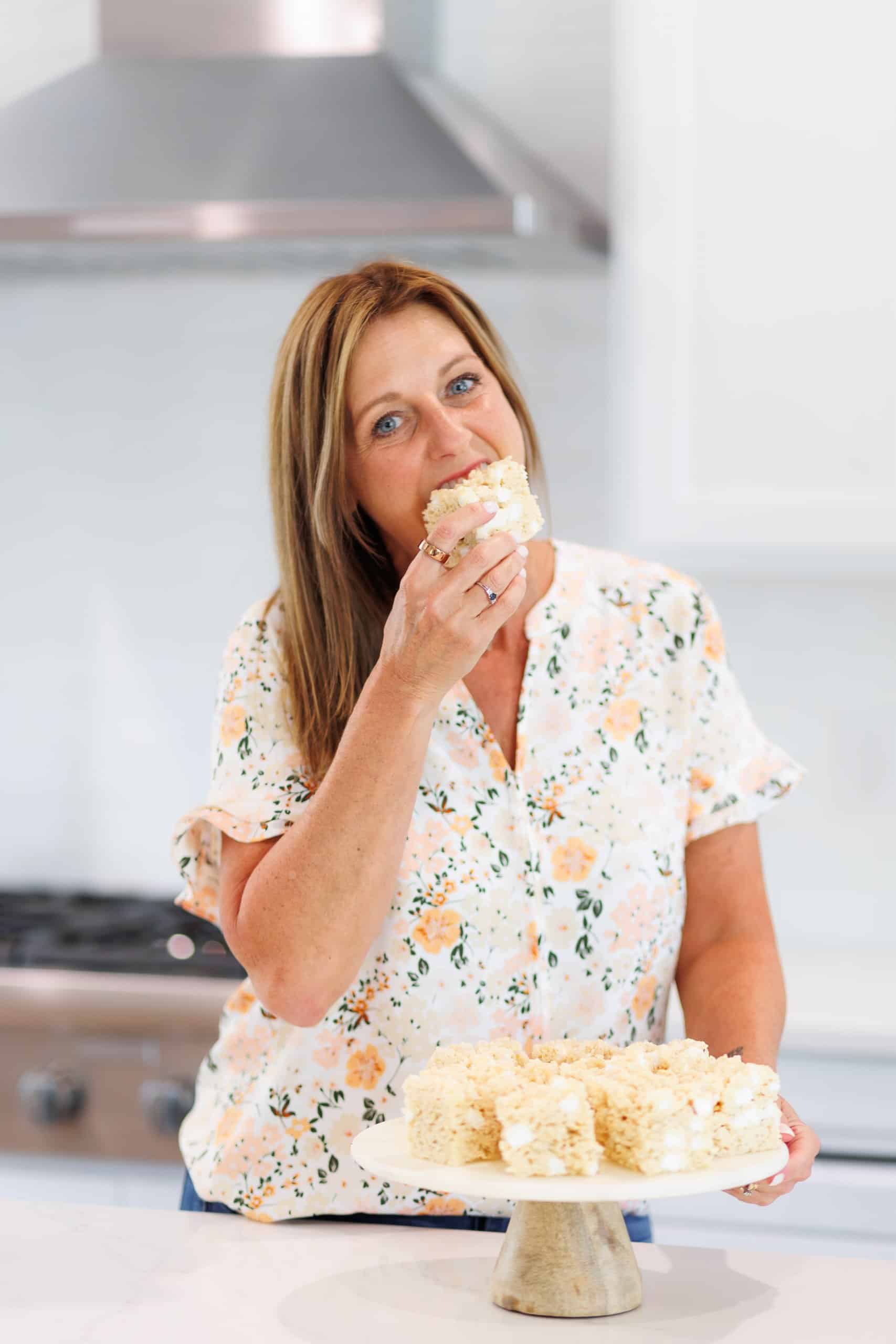 Aimee Shugarman taking a bite of a rice krispie treat.