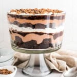 This chocolate Brownie Trifle recipe couldn't be simpler! Homemade brownies layered with fluffy chocolate mousse, hot fudge, toffee bits, and Cool Whip for a rich dessert.